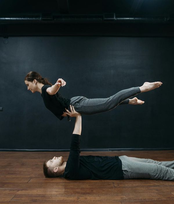 Strong man performing a controlled physical exercise in a studio